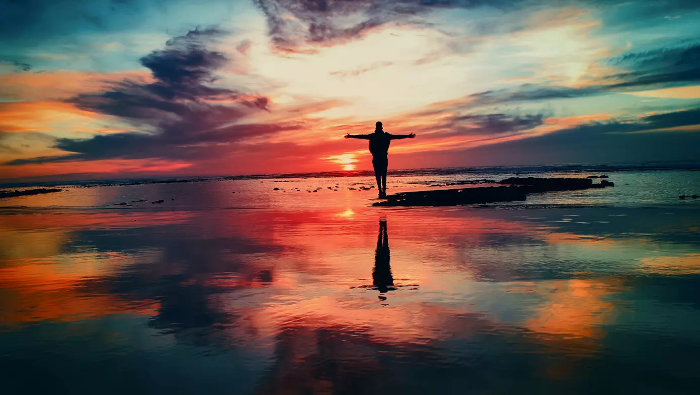 man in front of the universe sky